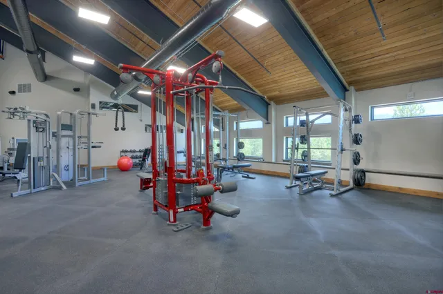 a room with gym equipment and a large window