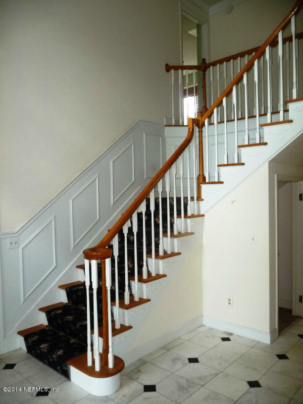 3049 Front Road Jacksonville, FL 32257 - Photo 12 of 30 a view of staircase with lots of frames on wall and a window