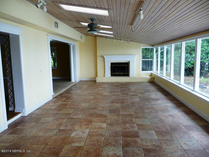 3049 Front Road Jacksonville, FL 32257 - Photo 13 of 30 a view of an empty room with a fireplace and a window