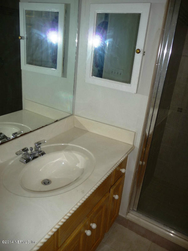 3049 Front Road Jacksonville, FL 32257 - Photo 3 of 30 a bathroom with a sink and mirror