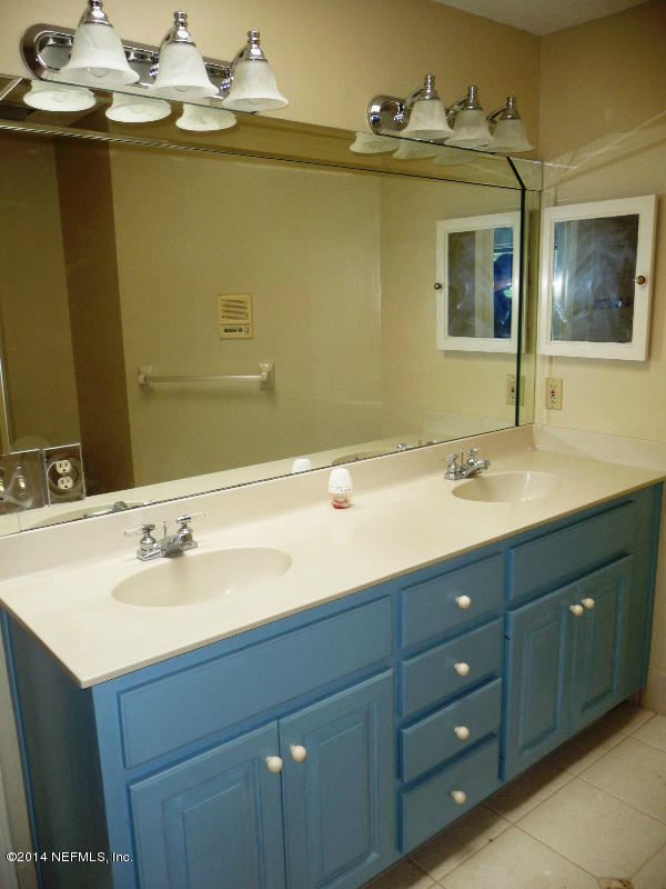 3049 Front Road Jacksonville, FL 32257 - Photo 5 of 30 a bathroom with a double vanity sink and a mirror