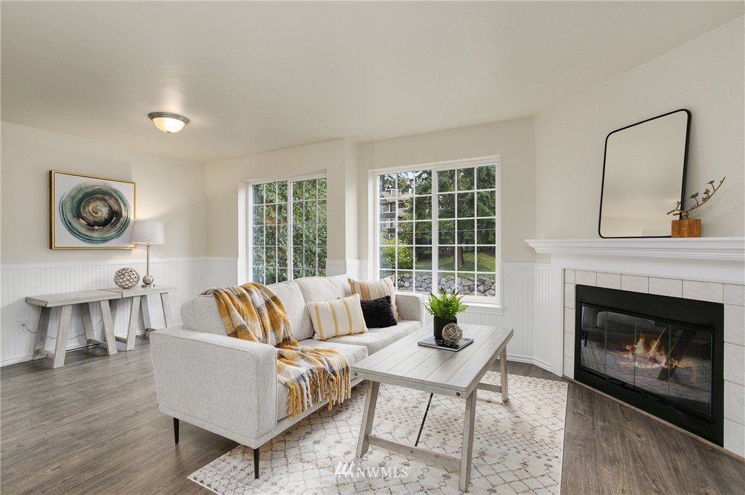 23317 Edmonds Way, Unit 8 Edmonds, WA 98026 - Photo 1 of 26 a living room with furniture a fireplace and a table