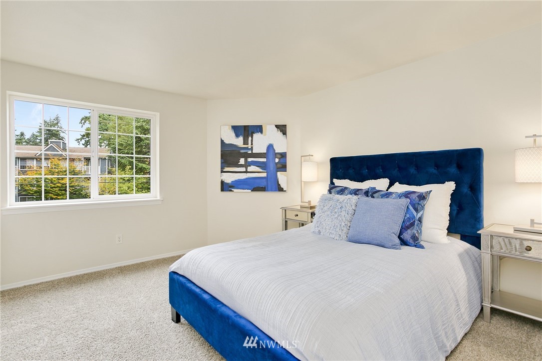 23317 Edmonds Way, Unit 8 Edmonds, WA 98026 - Photo 14 of 26 a bedroom with a large bed and a window
