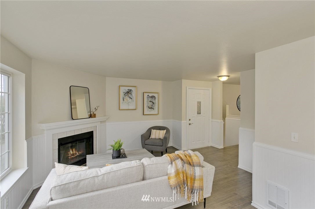 23317 Edmonds Way, Unit 8 Edmonds, WA 98026 - Photo 3 of 26 a bedroom with furniture and a fireplace