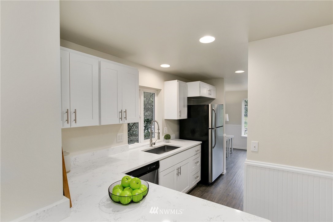 23317 Edmonds Way, Unit 8 Edmonds, WA 98026 - Photo 6 of 26 a kitchen with a sink and refrigerator