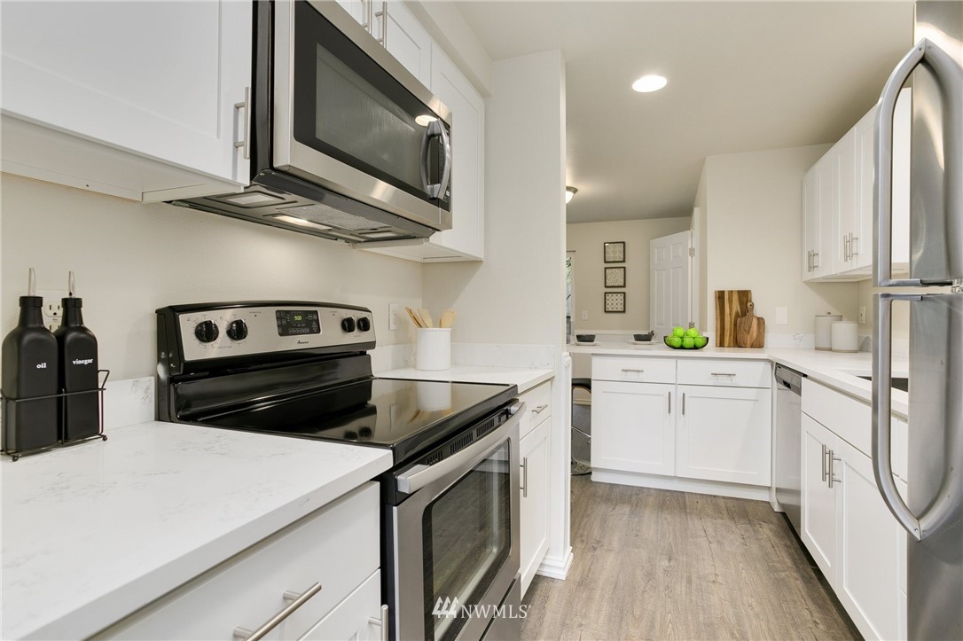 23317 Edmonds Way, Unit 8 Edmonds, WA 98026 - Photo 8 of 26 a kitchen with a stove microwave and sink