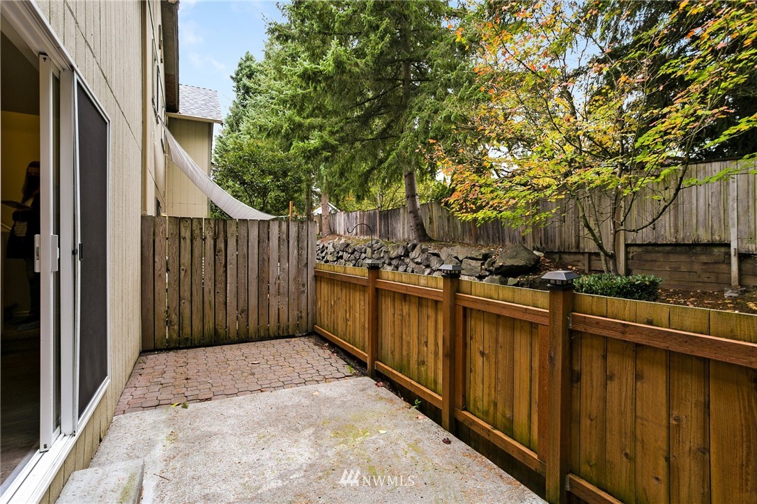 23317 Edmonds Way, Unit 8 Edmonds, WA 98026 - Photo 10 of 26 a view of a pathway of a patio with wooden fence and trees
