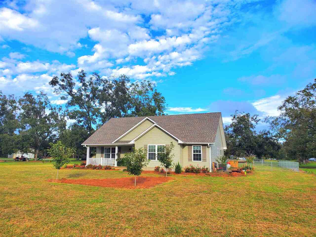 598 Windmill Road Metter, GA 30439 - Photo 1 of 1 a front view of house with swimming pool and green space