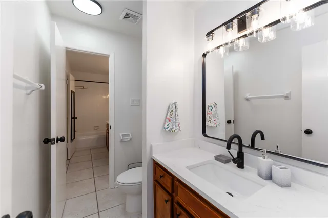 a bathroom with a double vanity sink and mirror