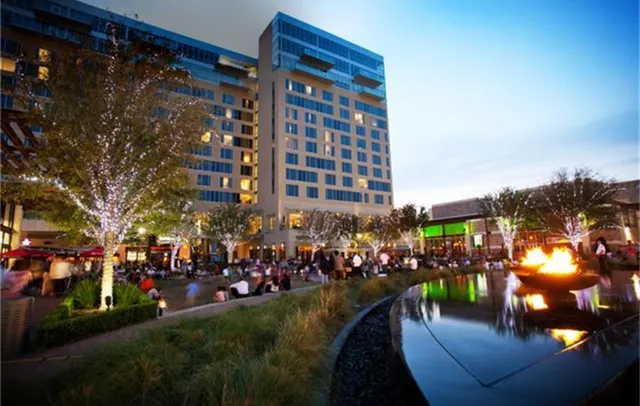 a city street lined with lots of buildings and trees