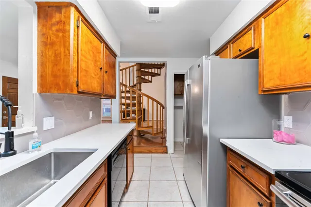 a kitchen with stainless steel appliances granite countertop a sink and cabinets