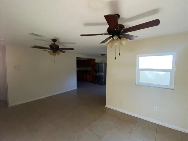 a view of a livingroom with a ceiling fan and a ceiling fan