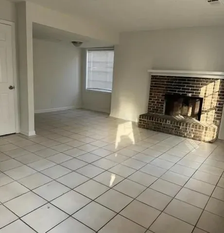 a view of an empty room and fire place