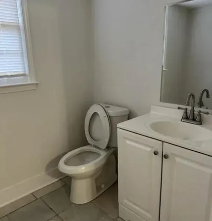 a white toilet sitting next to a bathroom sink