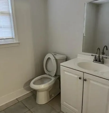 a white toilet sitting next to a bathroom sink