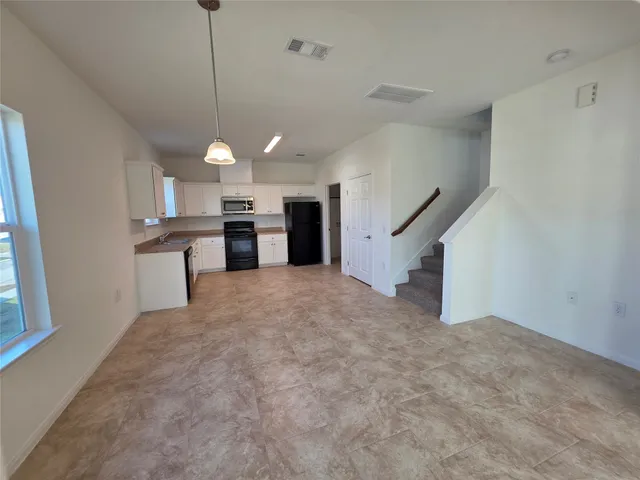 a view of a kitchen with a sink cabinets and a window