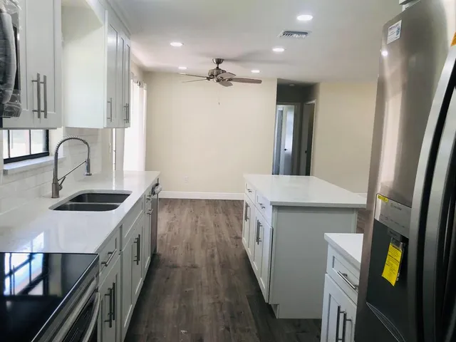 a kitchen with a sink and a refrigerator