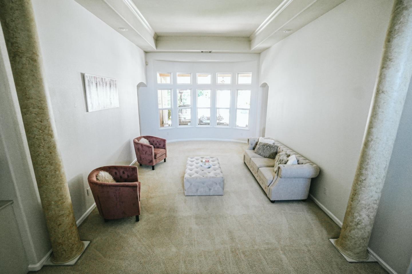 4609 Vía Fiori Modesto, CA 95357 - Photo 13 of 44 a hallway with furniture and a window