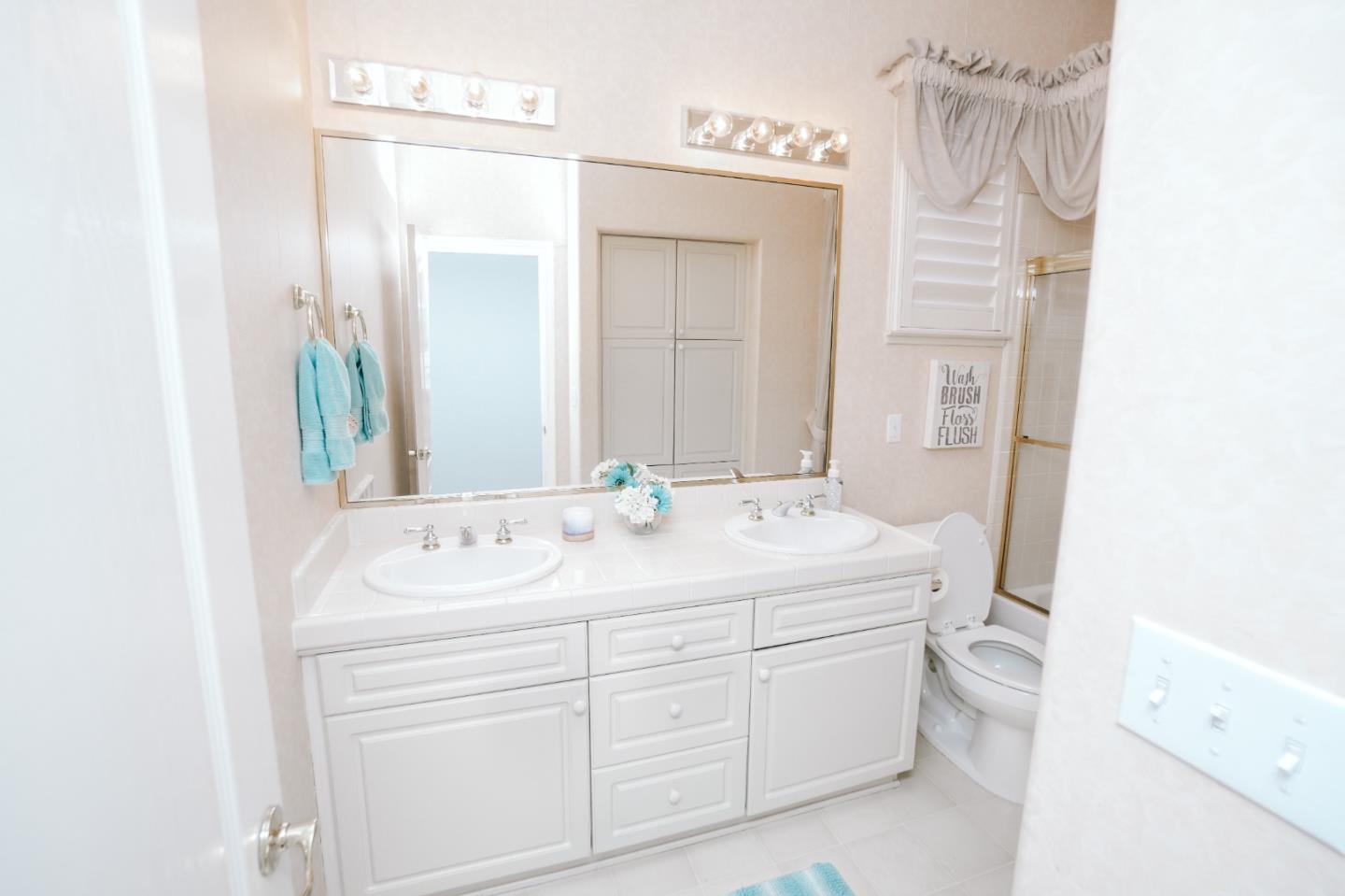 4609 Vía Fiori Modesto, CA 95357 - Photo 14 of 44 a bathroom with a sink and a mirror