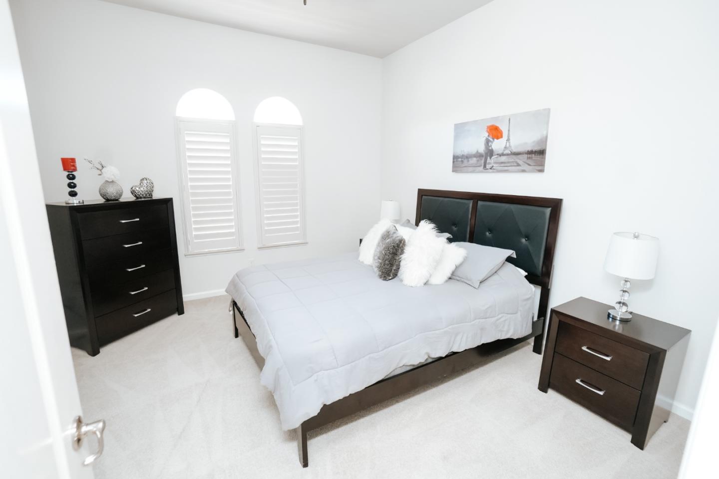 4609 Vía Fiori Modesto, CA 95357 - Photo 17 of 44 a bedroom with a bed and a window