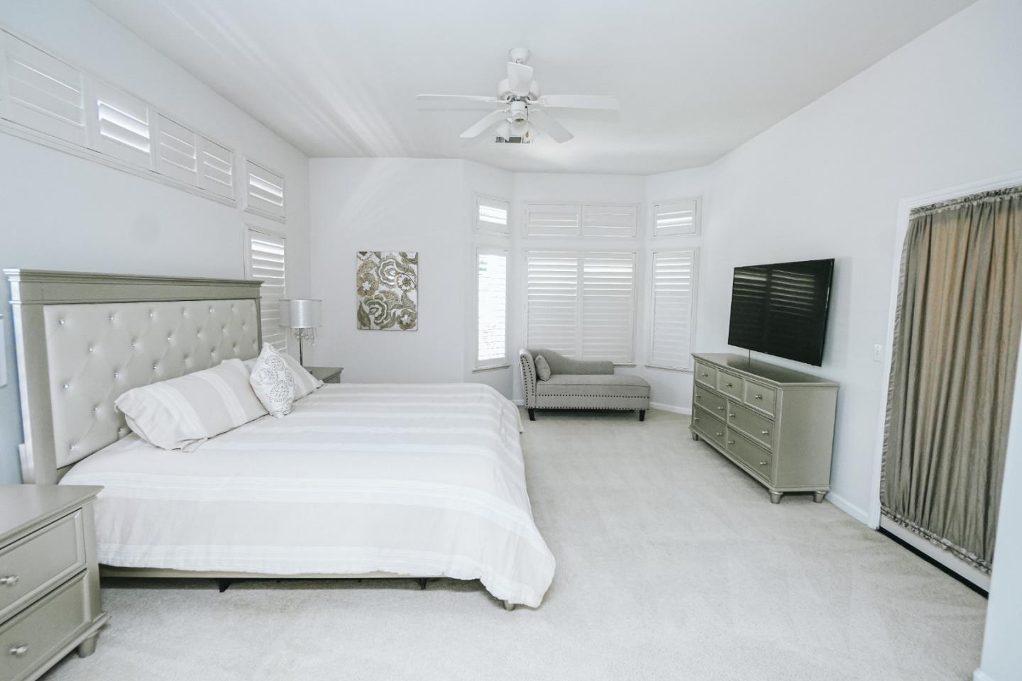 4609 Vía Fiori Modesto, CA 95357 - Photo 19 of 44 a spacious bedroom with a bed and a flat screen tv