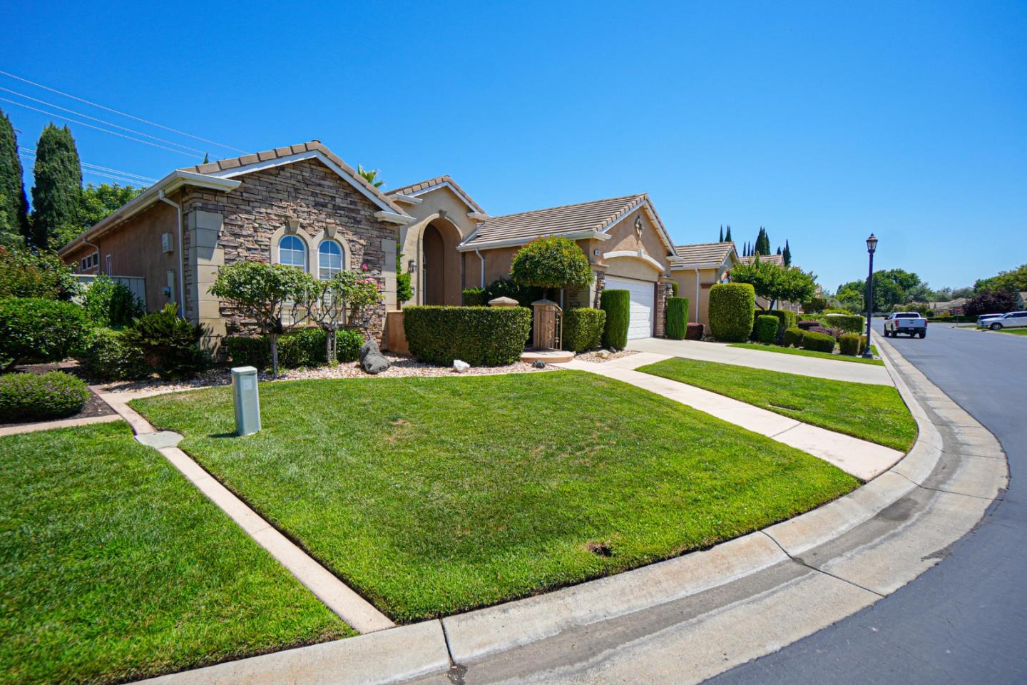 4609 Vía Fiori Modesto, CA 95357 - Photo 2 of 44 a view of a house with a big yard plants and palm trees