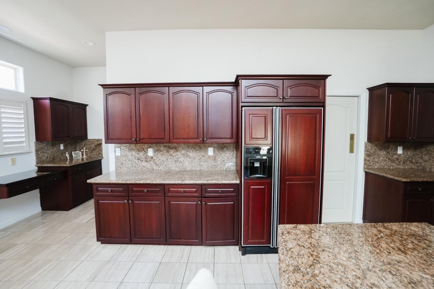 4609 Vía Fiori Modesto, CA 95357 - Photo 30 of 44 a kitchen with granite countertop stainless steel appliances and wooden cabinets