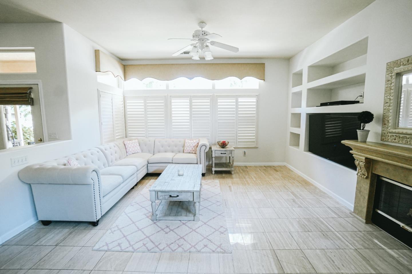 4609 Vía Fiori Modesto, CA 95357 - Photo 32 of 44 a living room with furniture and a fireplace