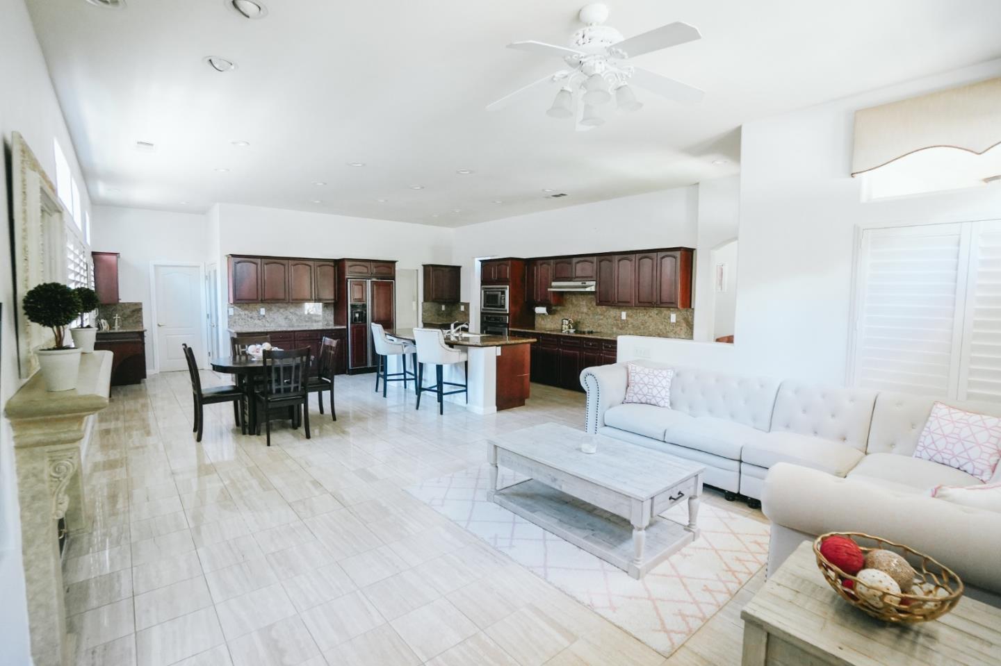 4609 Vía Fiori Modesto, CA 95357 - Photo 33 of 44 a living room with furniture and a dining area with kitchen view