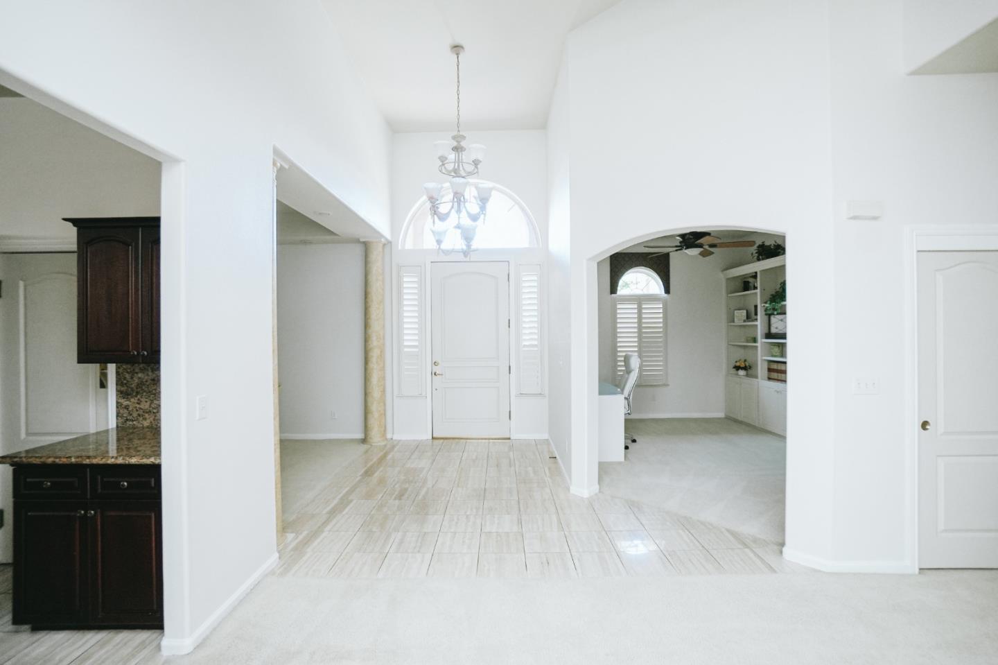 4609 Vía Fiori Modesto, CA 95357 - Photo 7 of 44 en empty room with kitchen chandelier and glass door