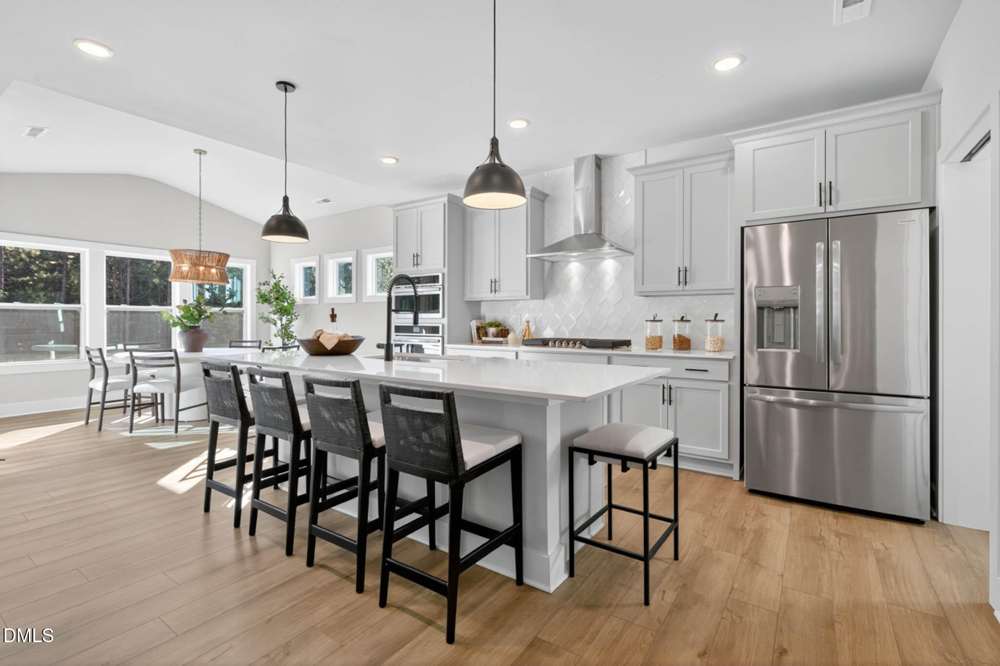 778 Beacon Hl Road Lillington, NC 27546 - Photo 14 of 44 a kitchen with stainless steel appliances granite countertop a refrigerator a stove a sink dishwasher a dining table and chairs with wooden floor