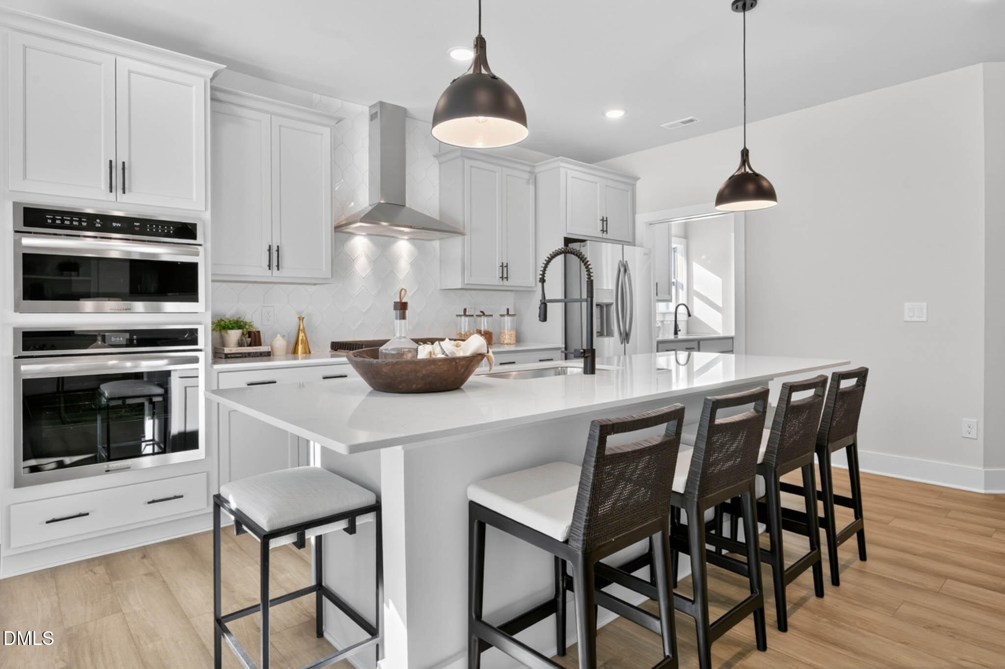 778 Beacon Hl Road Lillington, NC 27546 - Photo 17 of 44 a kitchen with stainless steel appliances a dining table chairs and white cabinets