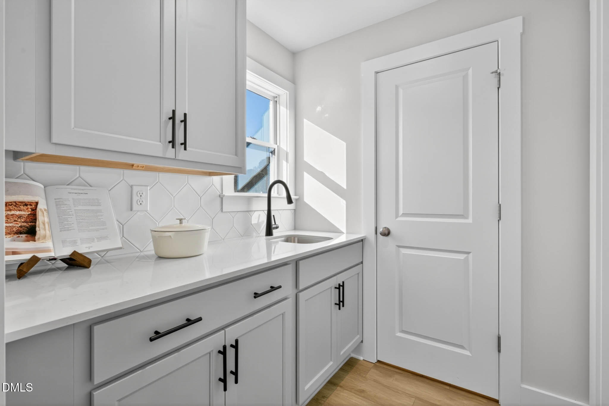 778 Beacon Hl Road Lillington, NC 27546 - Photo 18 of 44 a kitchen with white cabinets and sink