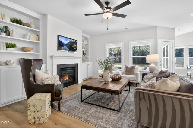 a living room with furniture fireplace and flat screen tv