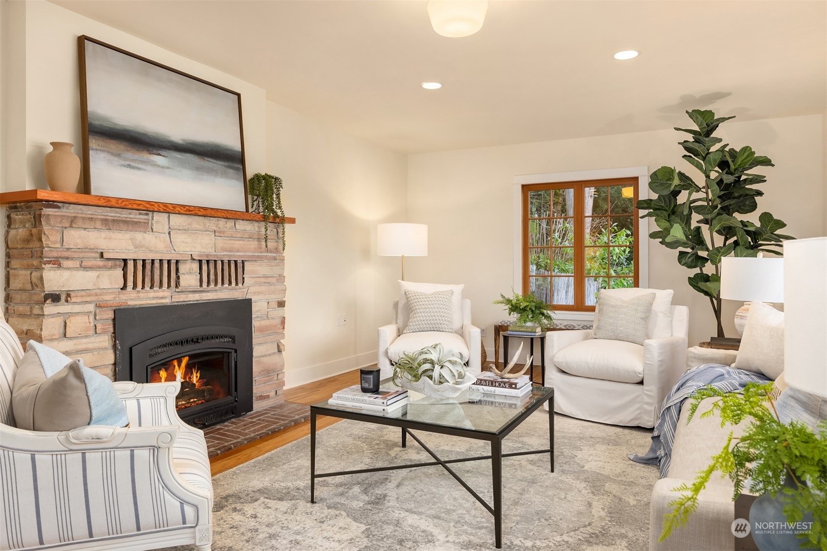 8260 Northeast Hidden Cove Road Bainbridge Island, WA 98110 - Photo 11 of 35 a living room with furniture a fireplace and a potted plant