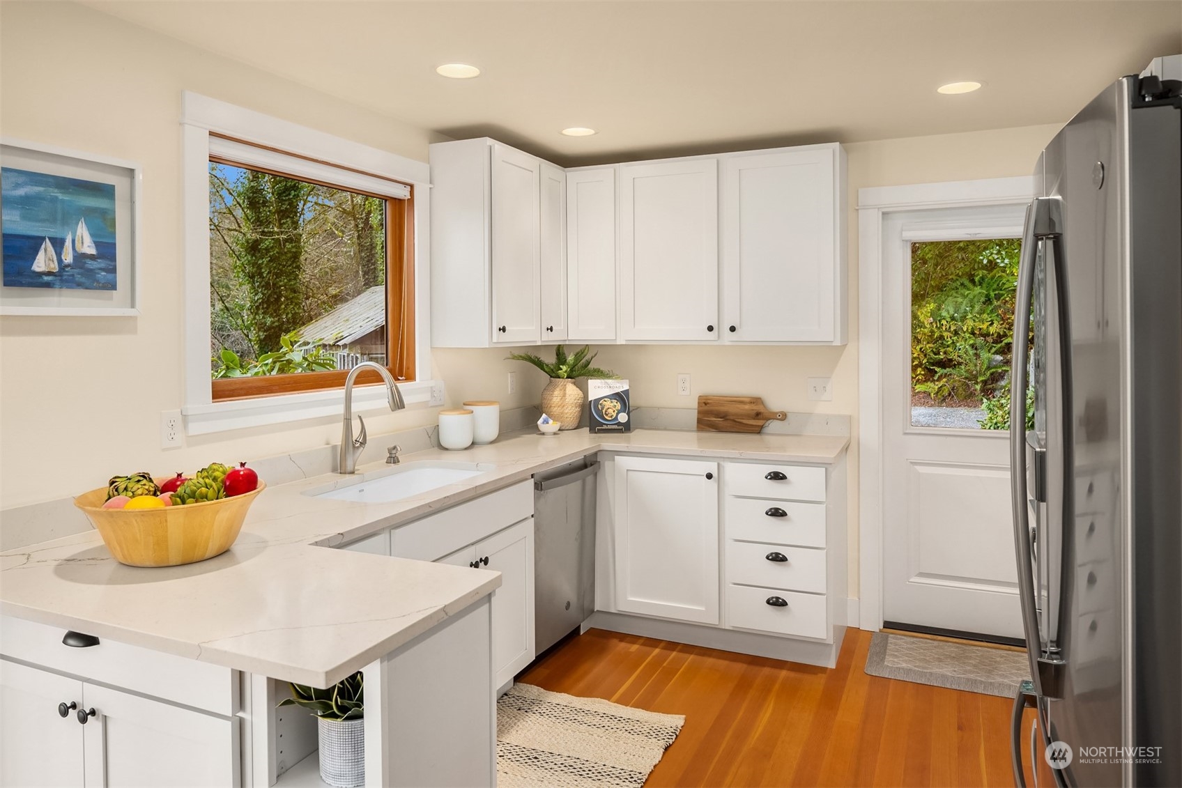 8260 Northeast Hidden Cove Road Bainbridge Island, WA 98110 - Photo 16 of 35 a kitchen with white cabinets and window