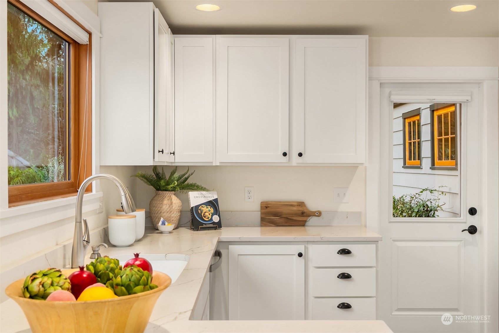 8260 Northeast Hidden Cove Road Bainbridge Island, WA 98110 - Photo 17 of 35 a kitchen with a sink and cabinets