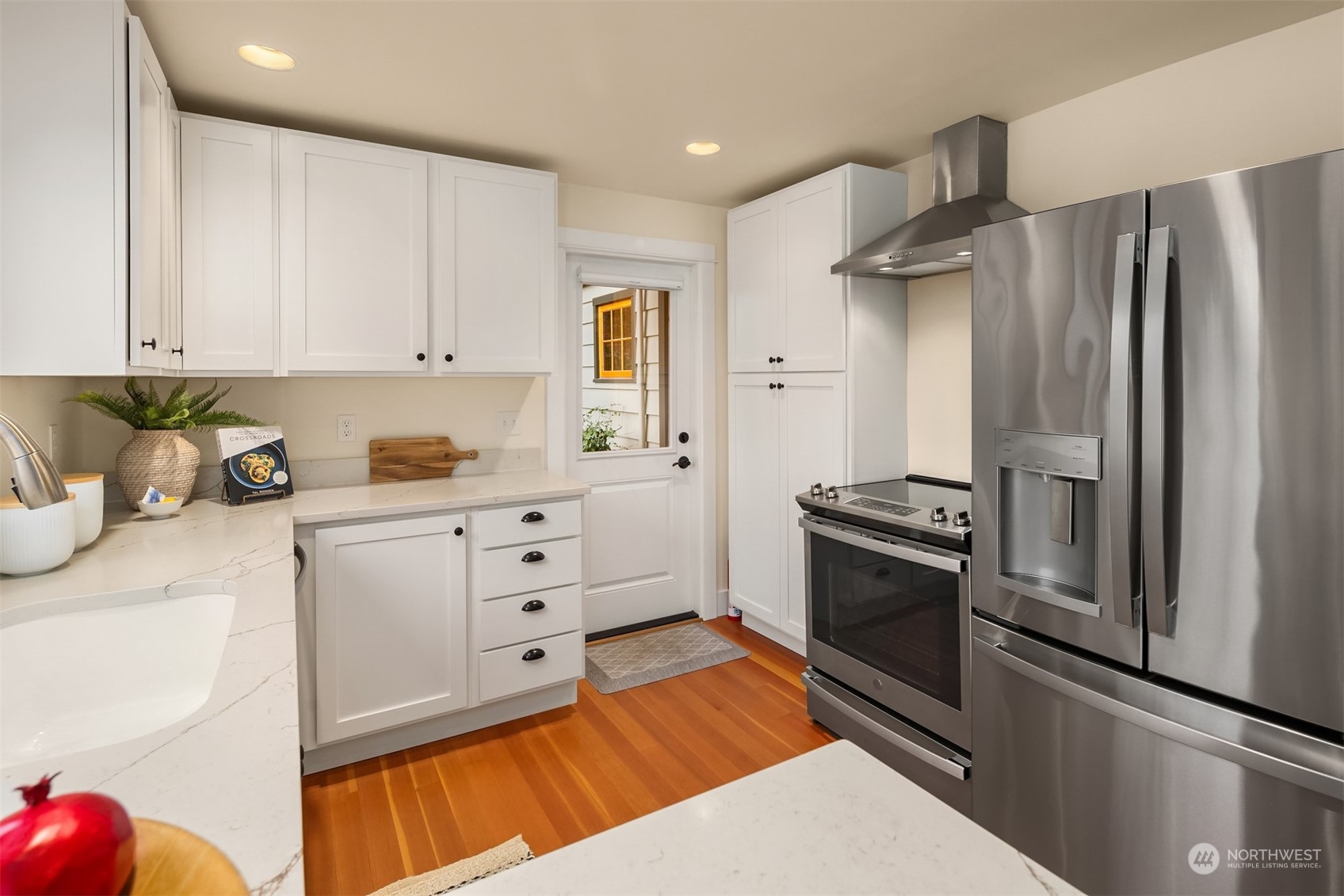8260 Northeast Hidden Cove Road Bainbridge Island, WA 98110 - Photo 18 of 35 a kitchen with stainless steel appliances granite countertop a refrigerator sink and stove