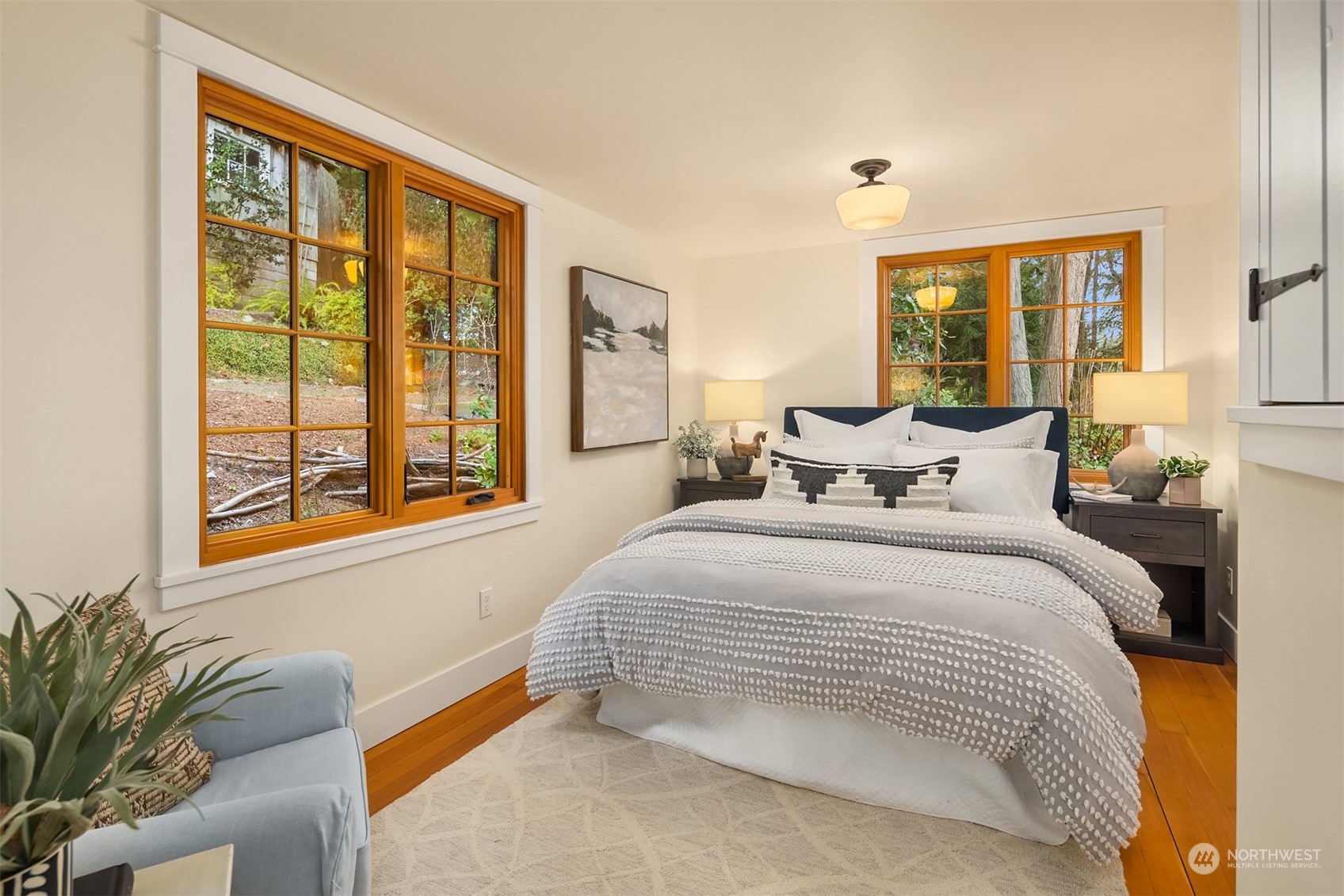 8260 Northeast Hidden Cove Road Bainbridge Island, WA 98110 - Photo 19 of 35 a bedroom with a large bed and a large window