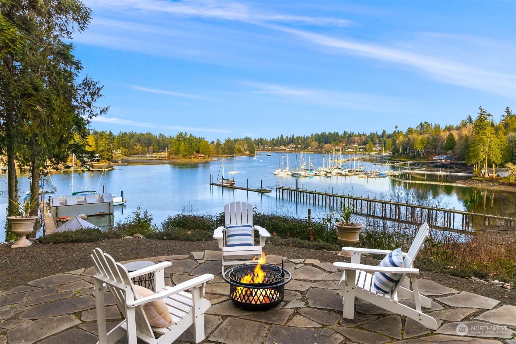 8260 Northeast Hidden Cove Road Bainbridge Island, WA 98110 - Photo 2 of 35 a view of a lake with couches chairs and a table
