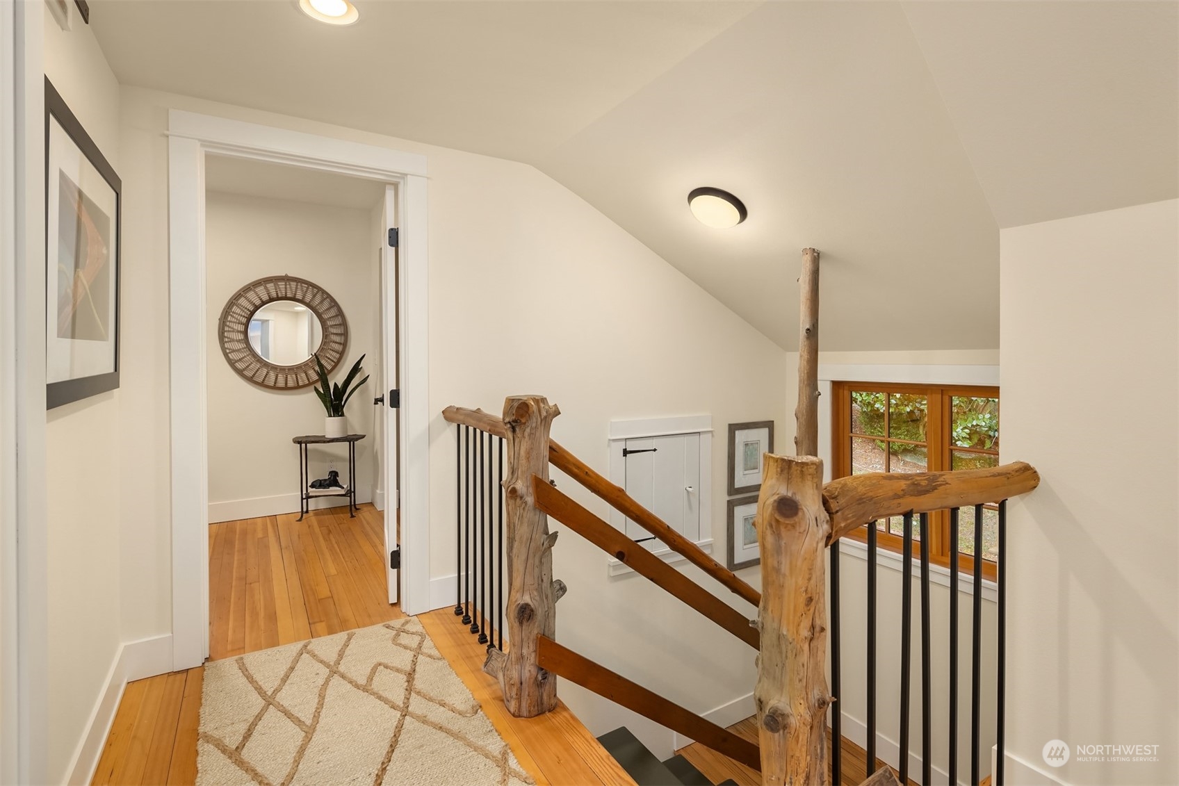 8260 Northeast Hidden Cove Road Bainbridge Island, WA 98110 - Photo 22 of 35 a view of a hallway with entryway wooden floor and front door