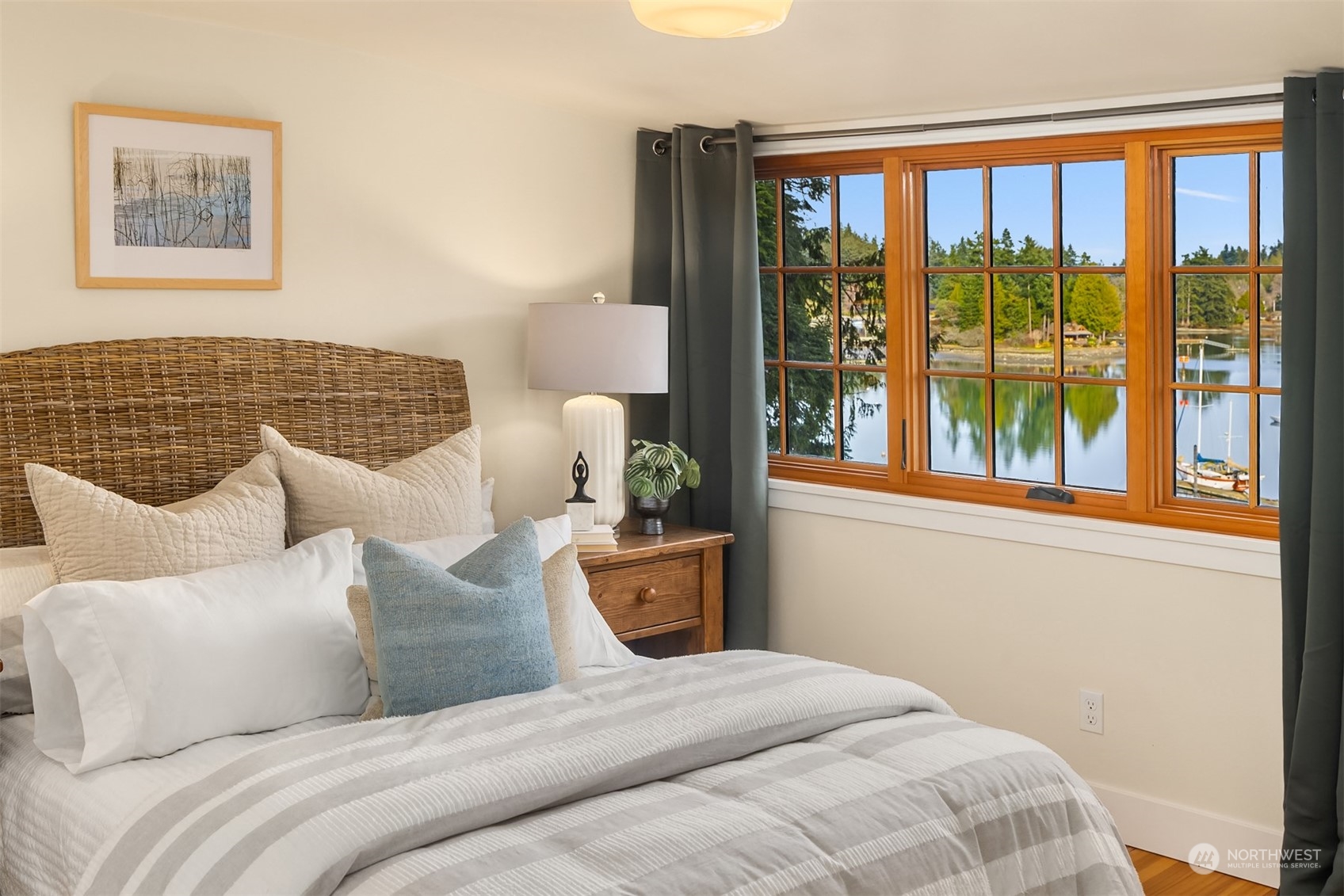 8260 Northeast Hidden Cove Road Bainbridge Island, WA 98110 - Photo 24 of 35 a bedroom with a large bed and a window