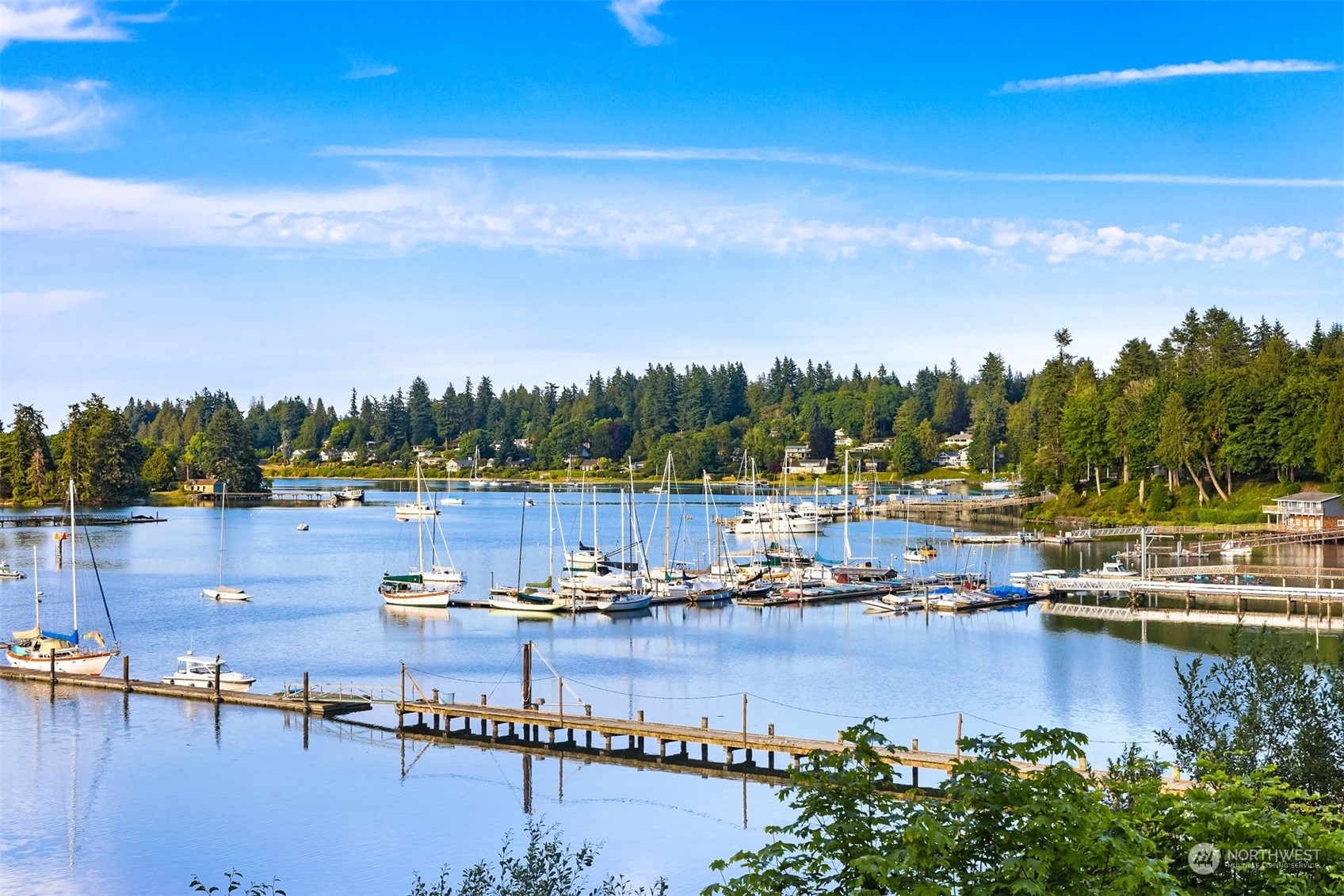 8260 Northeast Hidden Cove Road Bainbridge Island, WA 98110 - Photo 32 of 35 a view of water with boats and trees in the background