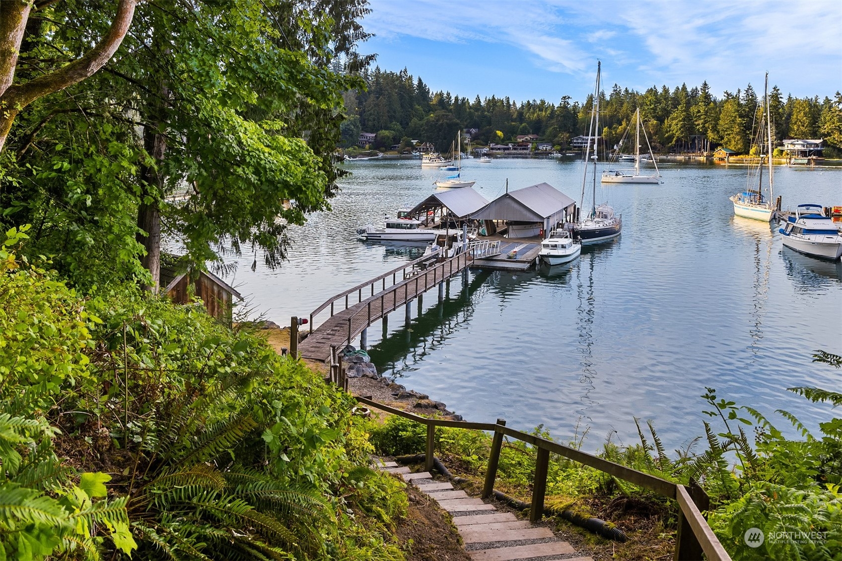 8260 Northeast Hidden Cove Road Bainbridge Island, WA 98110 - Photo 4 of 35 a view of a wooden bridge and lake view