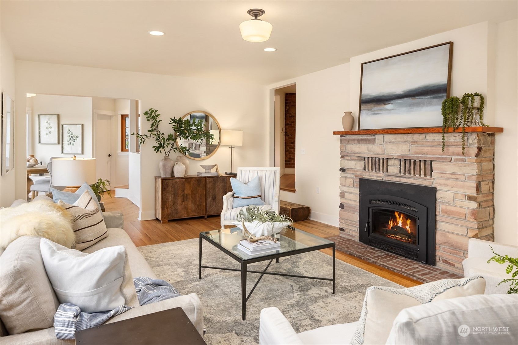 8260 Northeast Hidden Cove Road Bainbridge Island, WA 98110 - Photo 10 of 35 a living room with furniture and a fireplace