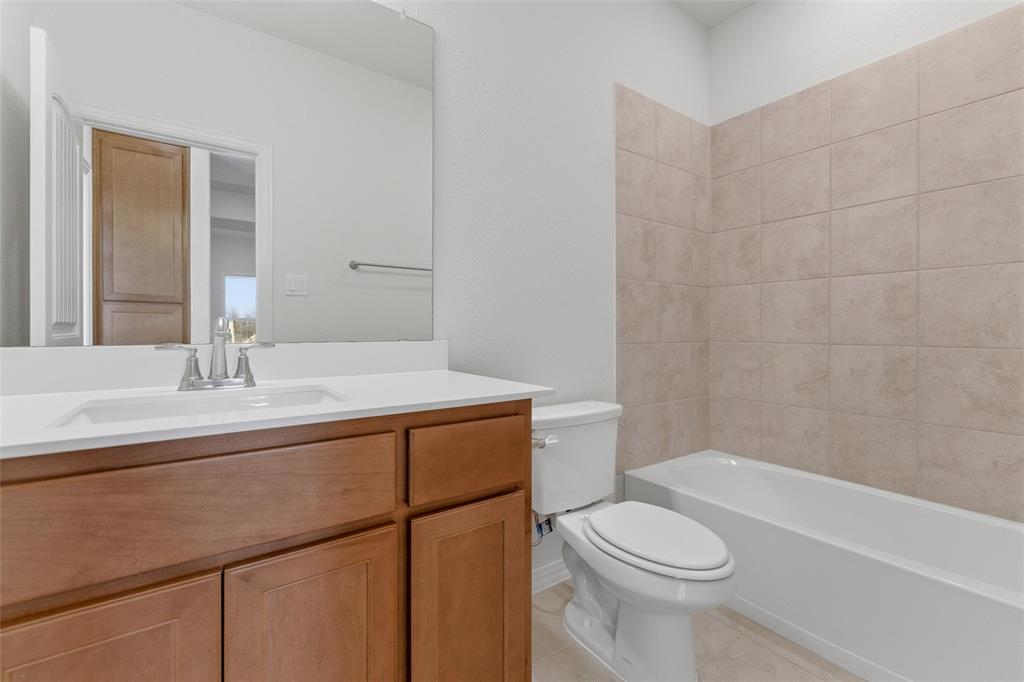 14408 Shooting Star Drive Haslet, TX 76052 - Photo 15 of 25 a bathroom with a sink a toilet and shower