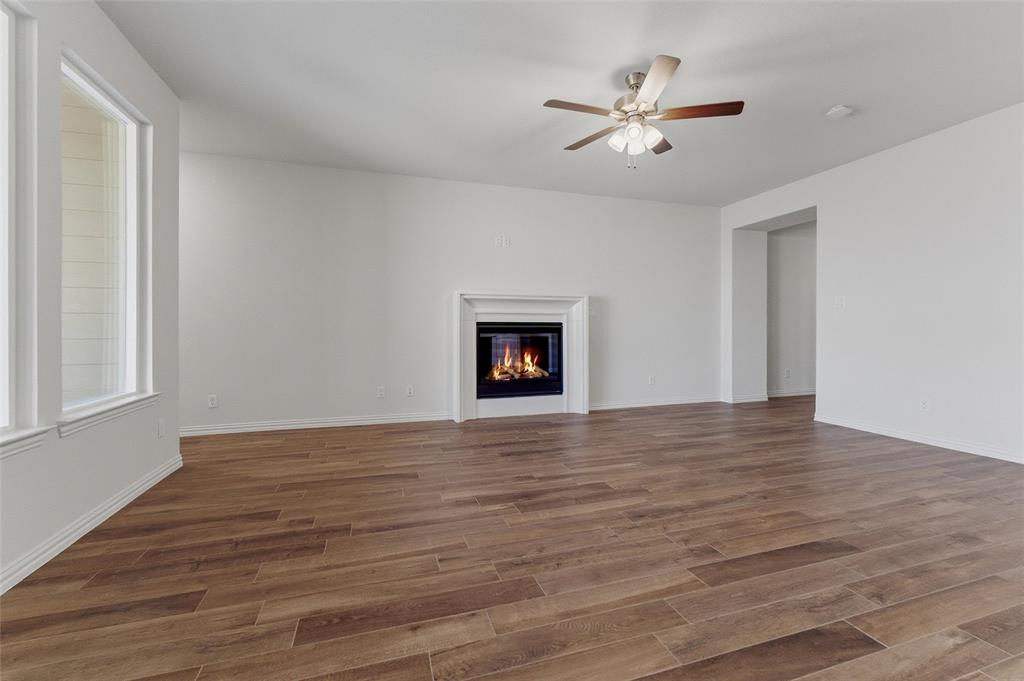 14408 Shooting Star Drive Haslet, TX 76052 - Photo 21 of 25 a view of an empty room with wooden floor and a ceiling fan