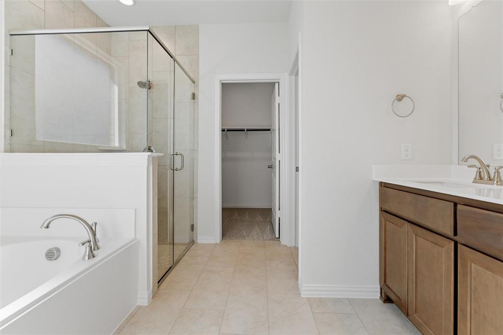 14408 Shooting Star Drive Haslet, TX 76052 - Photo 23 of 25 a bathroom with a sink a mirror and a bathtub