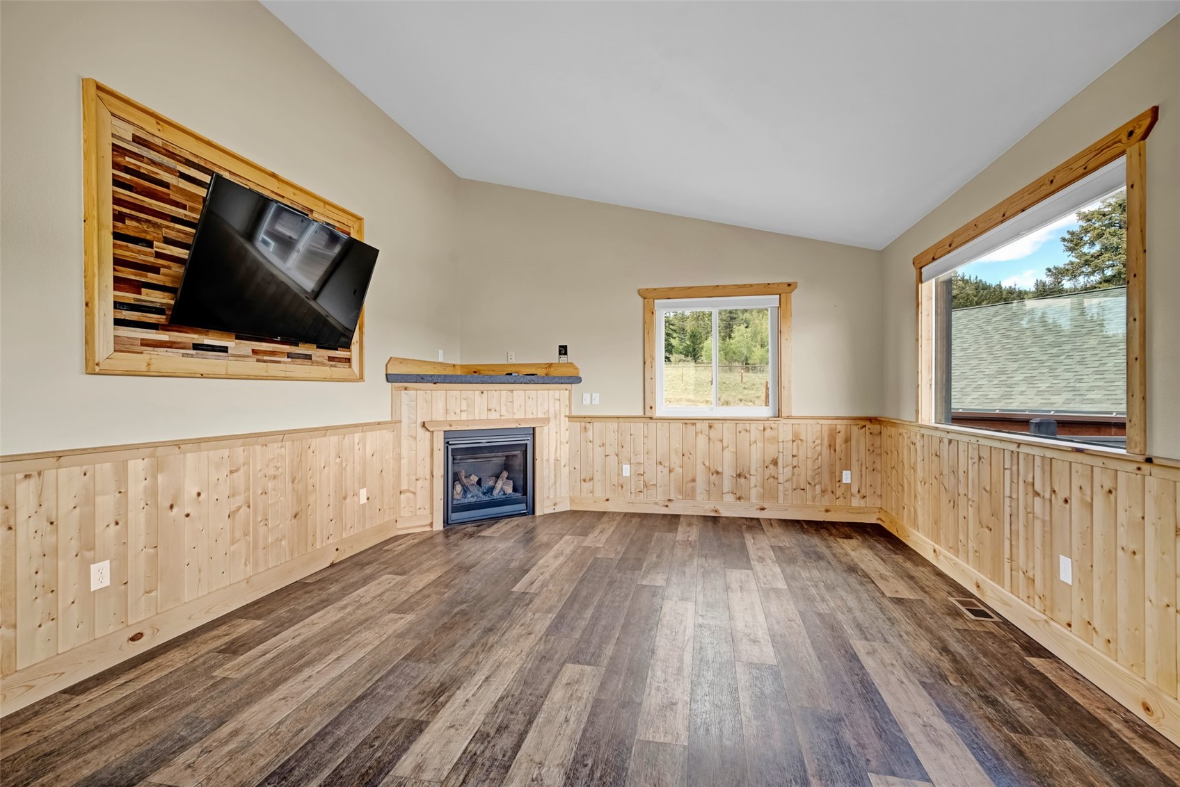 2491 Stagestop Road Jefferson, CO 80456 - Photo 8 of 43 a view of a livingroom with wooden floor fireplace and windows