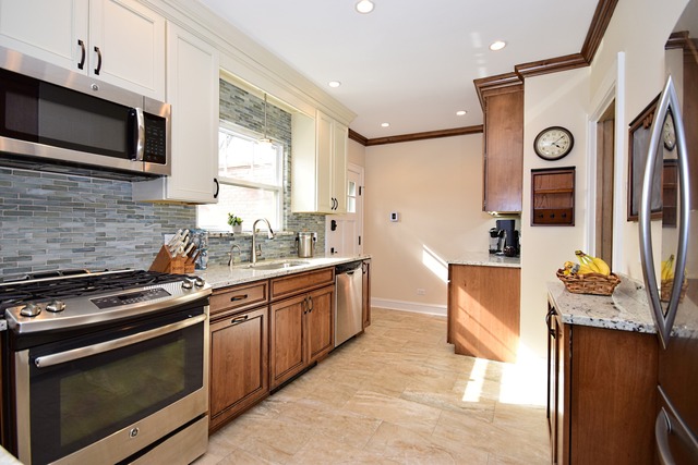 538 Byrd Road Riverside, IL 60546 - Photo 11 of 24 a kitchen with stainless steel appliances granite countertop a stove a sink and a microwave